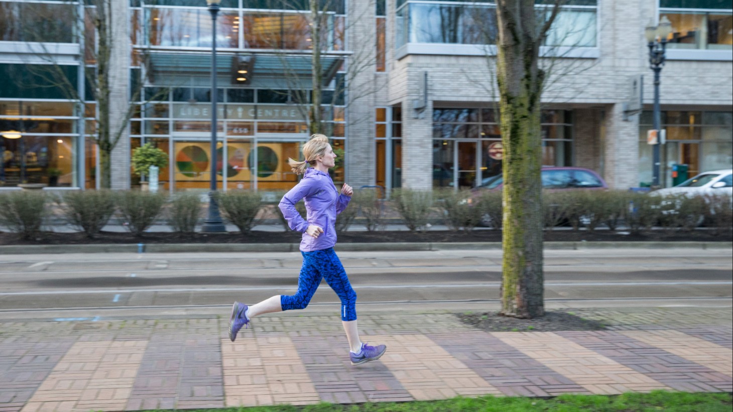 Woman jogging on a city sidewalk