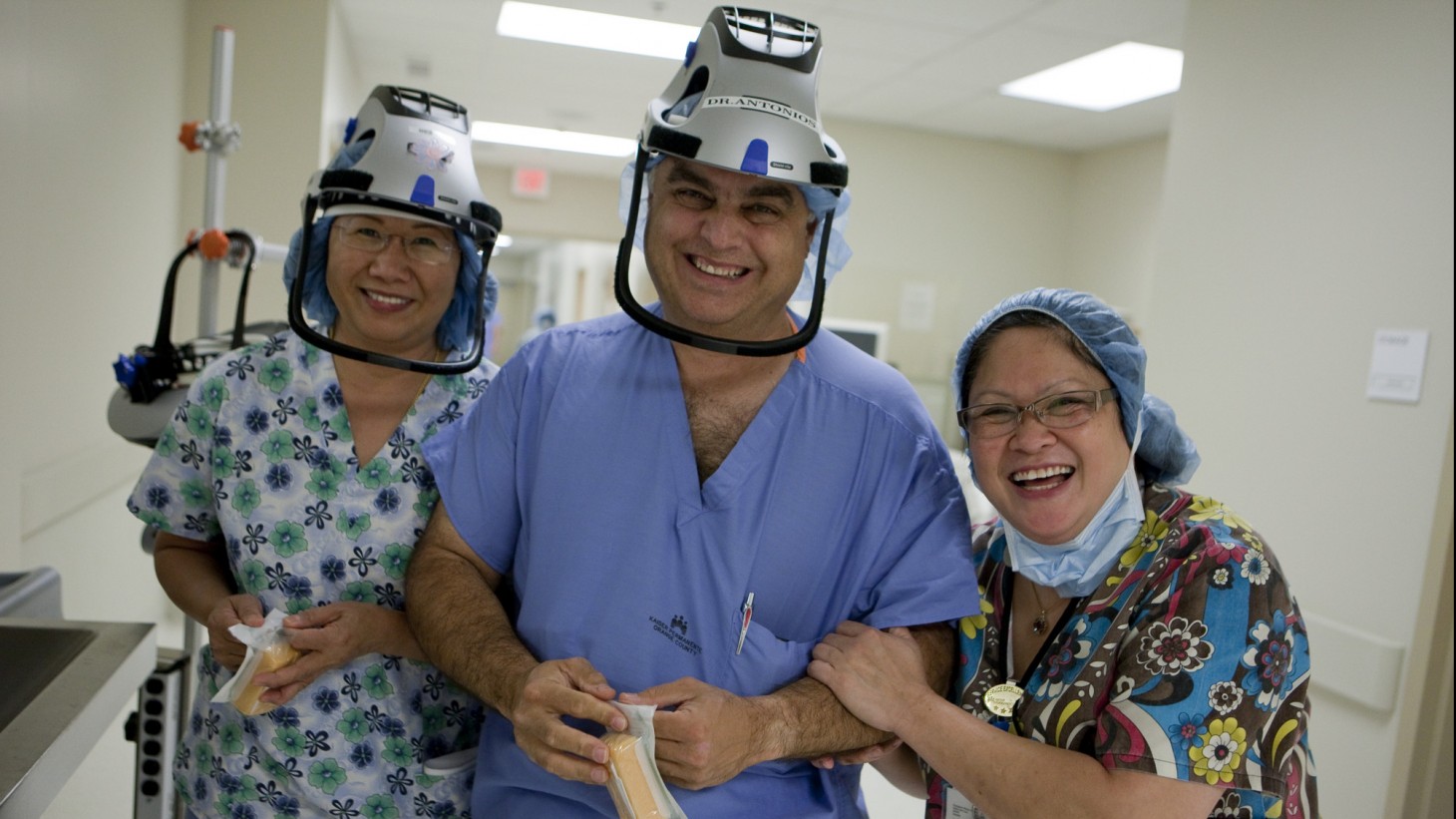 Three smiling health care workers, wearing interesting hats