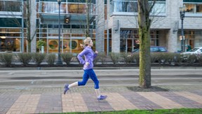 Woman jogging on a city sidewalk