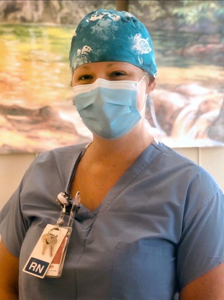 Nurse wearing blue scrubs and a blue mask